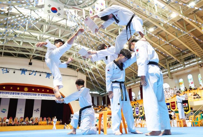 Jumping taekwondo kick to break board