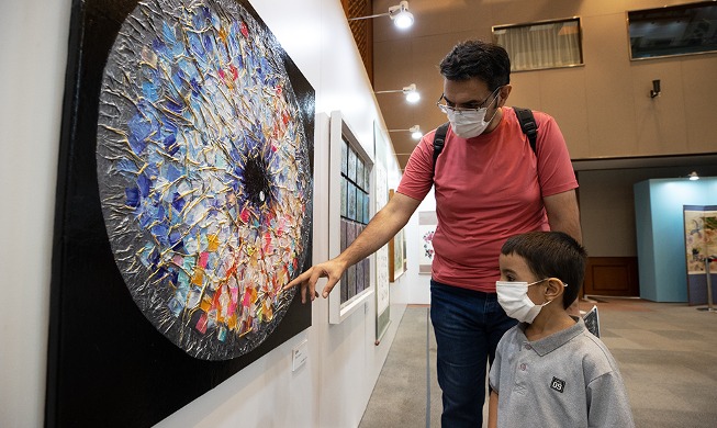 Man and son visit disabled artists' exhibition